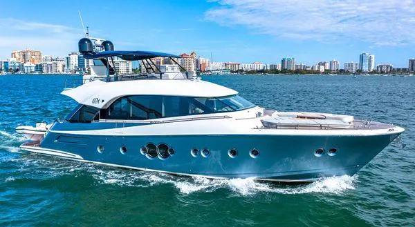 Slide: The Image of 2018 Monte Carlo Yachts MCY 70 cruising on blue waters near city skyline. - 6