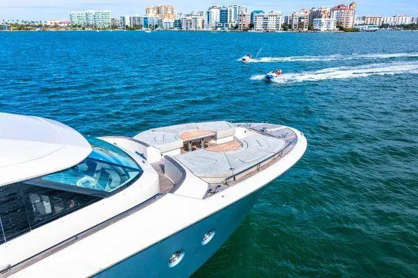 Slide: The Image of Monte Carlo Yachts MCY 70 cruising on blue waters, city skyline in background, 2018 model. - 4