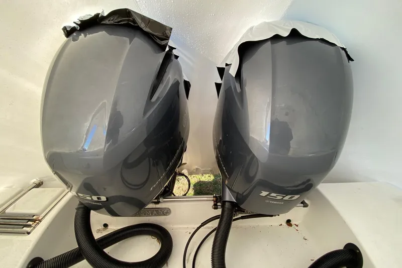 Slide: The Image of Twin Yamaha 150 outboard engines on a 2014 Sportsman Heritage 251 Center Console boat. - 11
