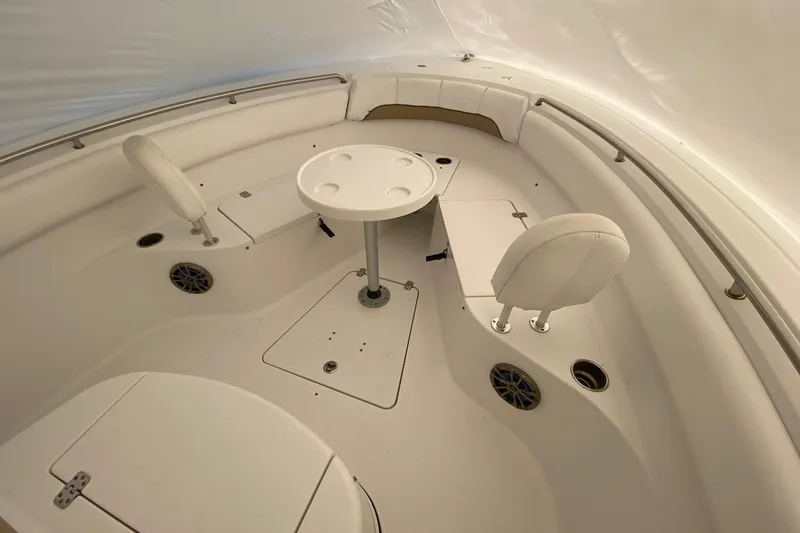 Slide: The Image of 2014 Sportsman Heritage 251 Center Console boat interior with seating and table. - 13