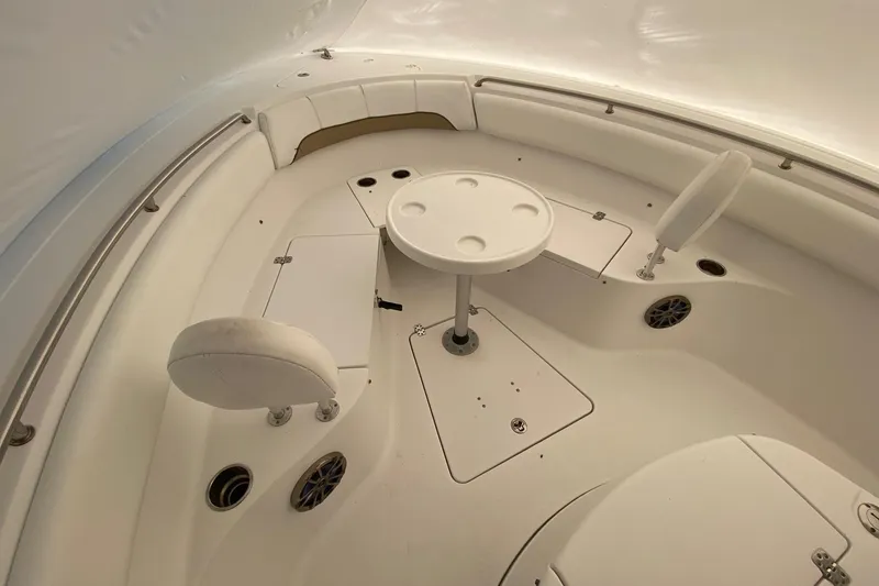 Slide: The Image of 2014 Sportsman Heritage 251 Center Console boat interior with seating and table. - 14