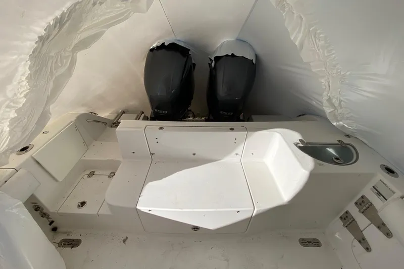 Slide: The Image of 2014 Sportsman Heritage 251 Center Console boat interior with dual engines. - 16