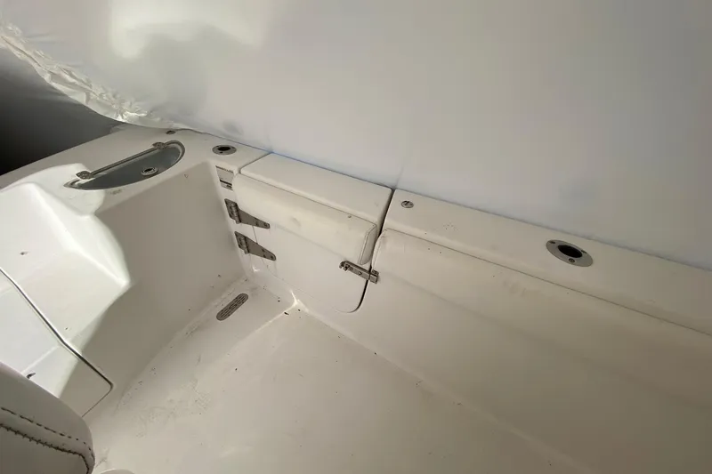 Slide: The Image of 2014 Sportsman Heritage 251 Center Console interior with storage compartment and seating area. - 17