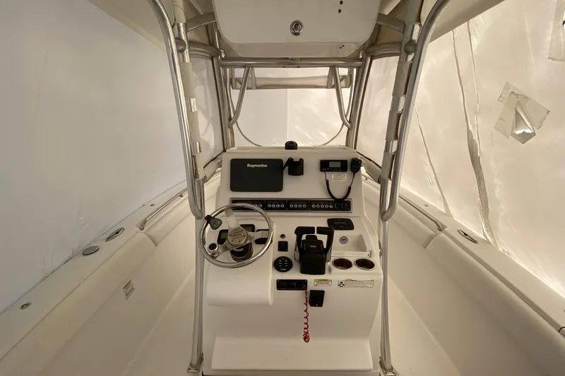 Slide: The Image of 2014 Sportsman Heritage 251 Center Console boat interior with steering wheel and controls. - 4