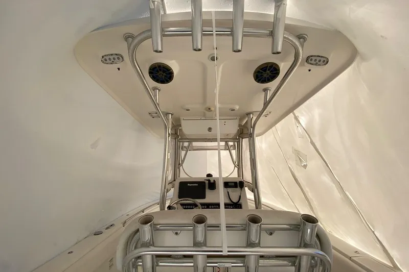 Slide: The Image of 2014 Sportsman Heritage 251 Center Console interior with fishing rod holders and electronics. - 5