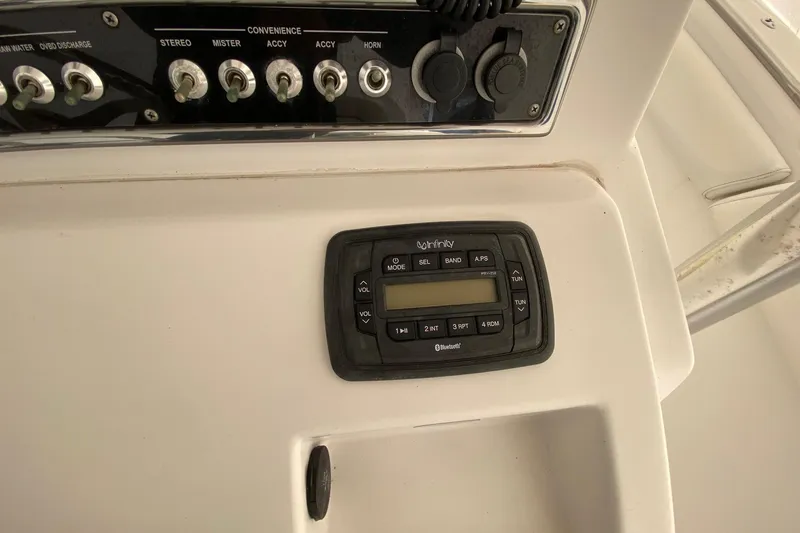 Slide: The Image of Control panel of 2014 Sportsman Heritage 251 Center Console boat with stereo system. - 9