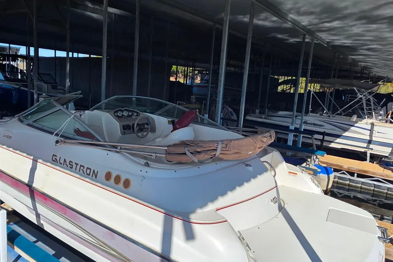 Slide: The Image of 2005 Glastron DX 235 boat docked in a covered marina. - 4