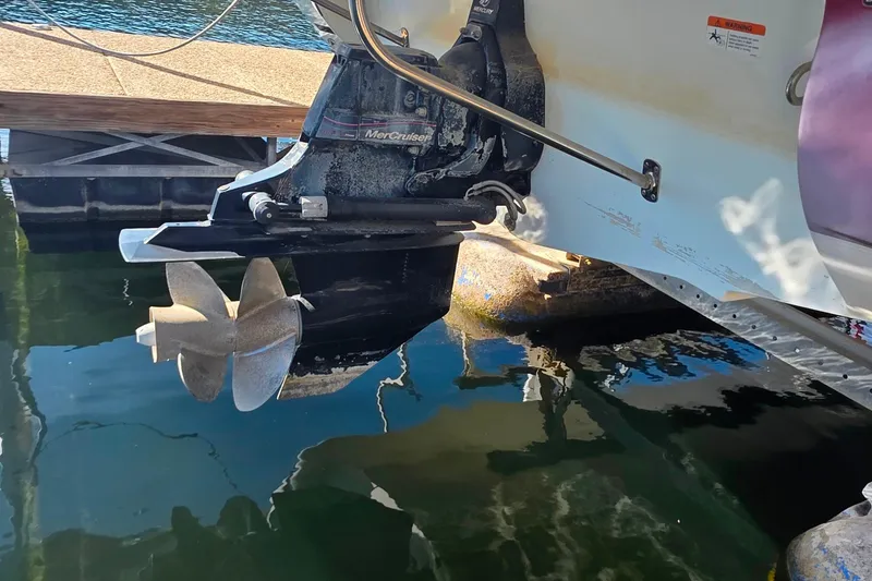 Slide: The Image of 2005 Glastron DX 235 boat with MerCruiser outdrive and propeller in water. - 8