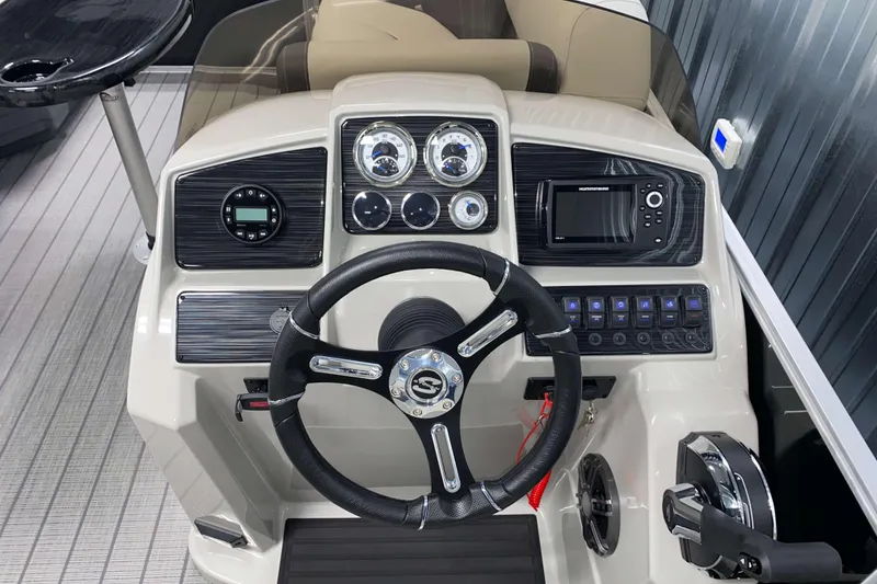 Slide: The Image of 2026 Sylvan Mirage 8520 CLZ DH boat dashboard with steering wheel and control panel. - 11