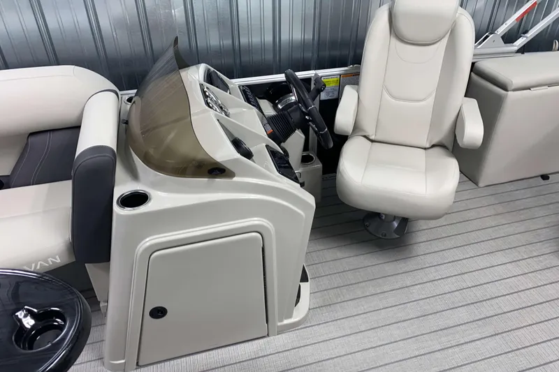 Slide: The Image of 2026 Sylvan Mirage 8520 CLZ DH boat interior with captain's chair and helm. - 9