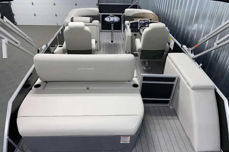 Slide: The Image of 2026 Sylvan Mirage 8520 CLZ DH PTS Tritoon interior with plush seating and modern design. - 12