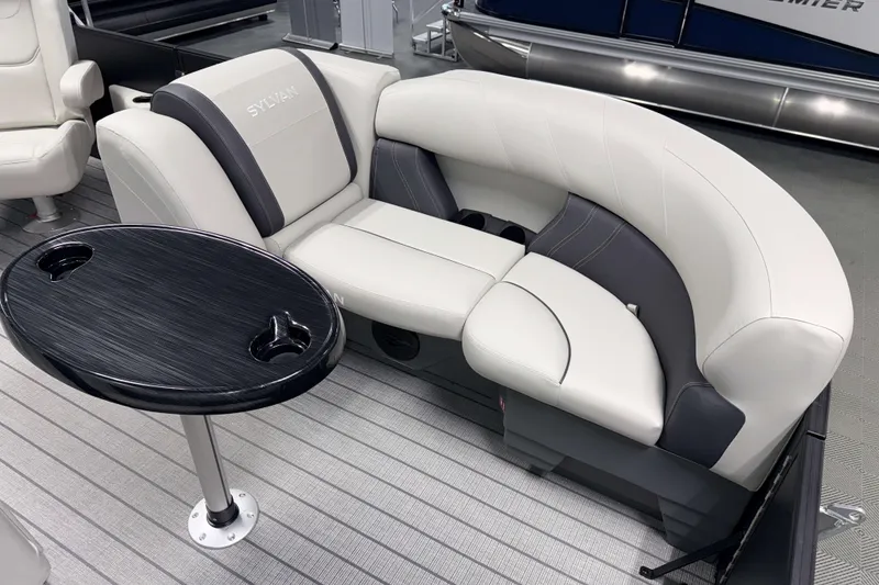 Slide: The Image of Luxurious seating on 2026 Sylvan Mirage 8520 CLZ DH PTS Tritoon boat with sleek table design. - 14