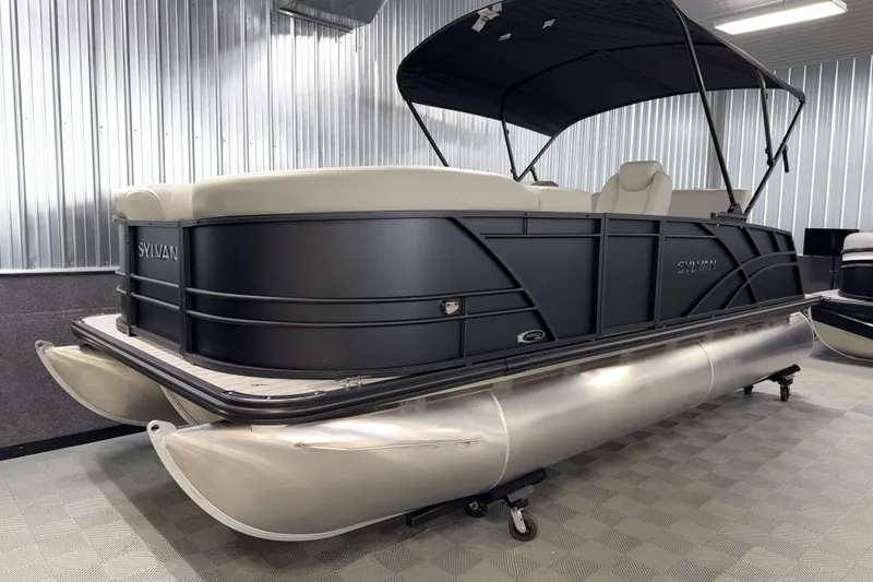 Slide: The Image of 2026 Sylvan Mirage 8520 CLZ DH PTS Tritoon in showroom, sleek design, black exterior. - 17