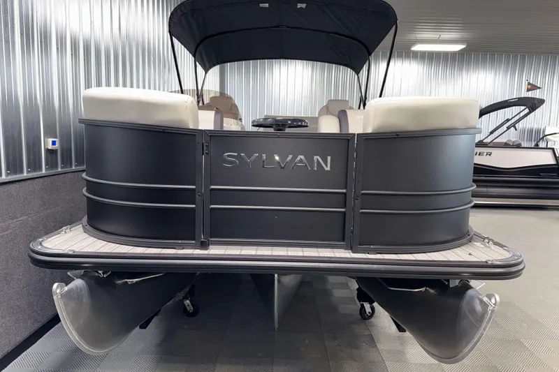 Slide: The Image of 2026 Sylvan Mirage 8520 CLZ DH PTS Tritoon in showroom, sleek design, black exterior. - 18