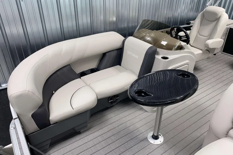 Slide: The Image of 2026 Sylvan Mirage 8520 CLZ DH PTS Tritoon interior with modern seating and helm. - 2