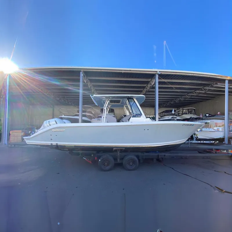 The Image of 2020 Pursuit S 288 Sport boat on trailer in covered storage area. - 0