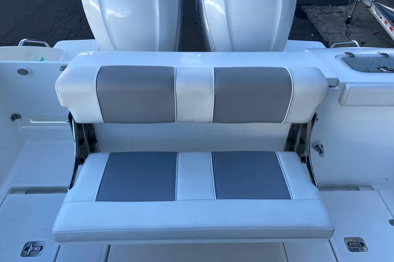 Slide: The Image of 2020 Pursuit S 288 Sport boat with gray and white cushioned seating. - 10