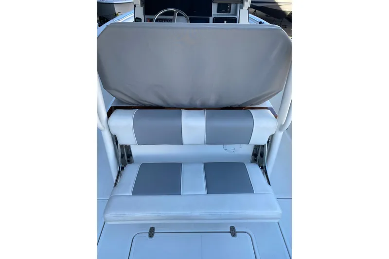 Slide: The Image of 2020 Pursuit S 288 Sport boat seating with gray and white upholstery. - 12