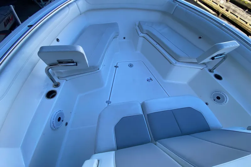 Slide: The Image of 2020 Pursuit S 288 Sport boat interior with cushioned seating and storage compartments. - 20