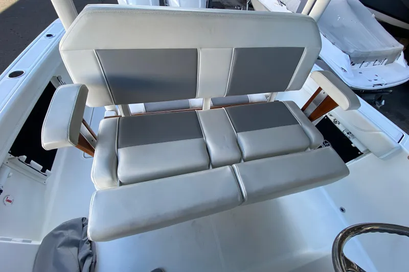 Slide: The Image of 2020 Pursuit S 288 Sport boat seating with cushioned armrests and gray upholstery. - 22