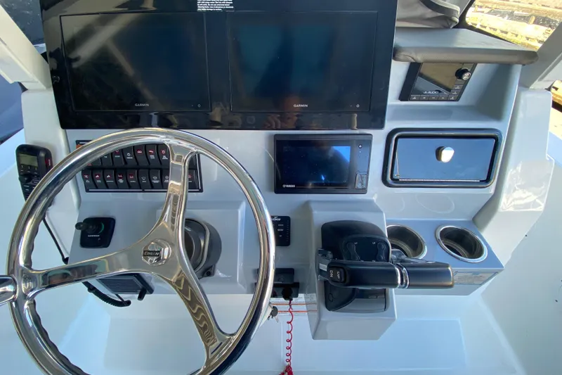 Slide: The Image of 2020 Pursuit S 288 Sport helm with steering wheel, controls, and navigation screens. - 23
