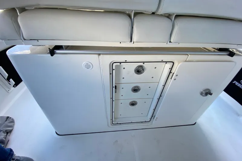 Slide: The Image of 2020 Pursuit S 288 Sport boat interior storage compartment with drawers. - 25