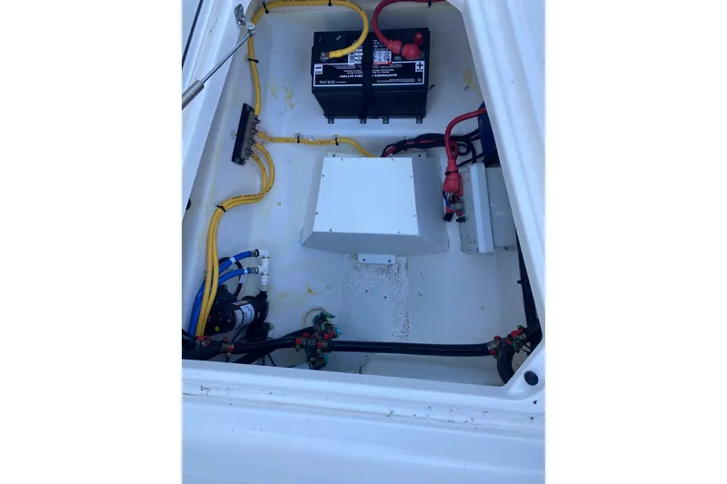 Slide: The Image of 2020 Pursuit S 288 Sport boat electrical compartment with battery and wiring. - 28