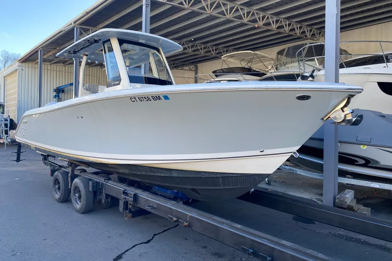 Slide: The Image of 2020 Pursuit S 288 Sport boat on trailer in storage facility. - 3