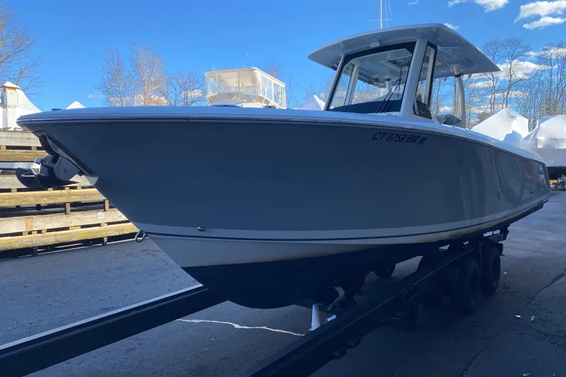 Slide: The Image of 2020 Pursuit S 288 Sport boat on trailer under clear blue sky. - 4