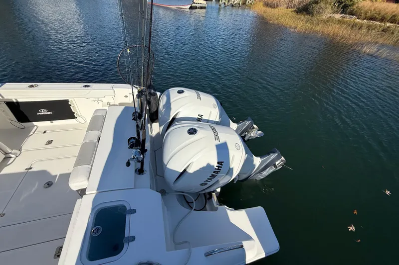 Slide: The Image of 2020 Pursuit S 288 Sport boat with twin Yamaha engines on calm water. - 8