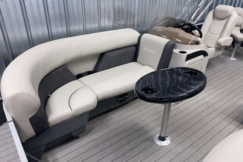Slide: The Image of 2026 Sylvan Mirage Fish 8520 Party Fish boat interior with plush seating and sleek table design. - 2