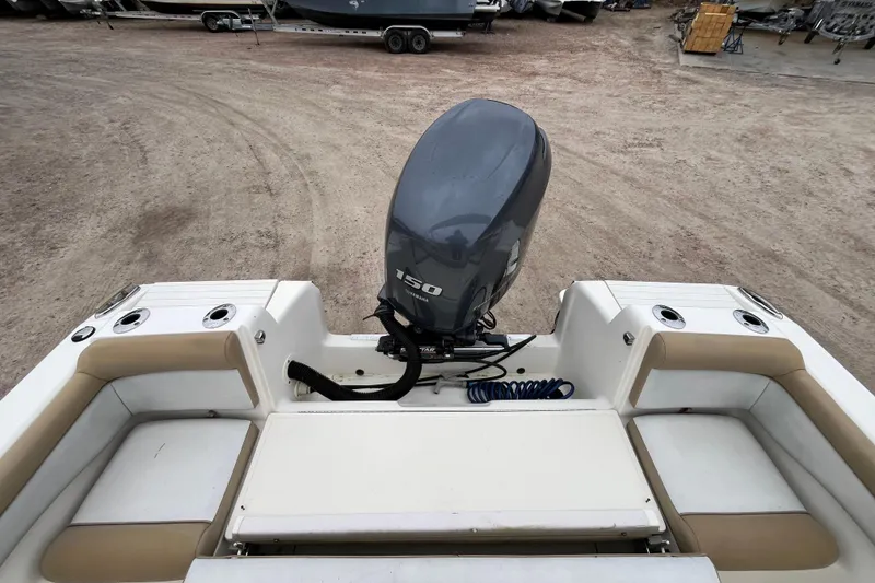 Slide: The Image of 2015 Scout 210 Dorado boat with Yamaha 150 outboard motor, beige seating, and cup holders. - 12