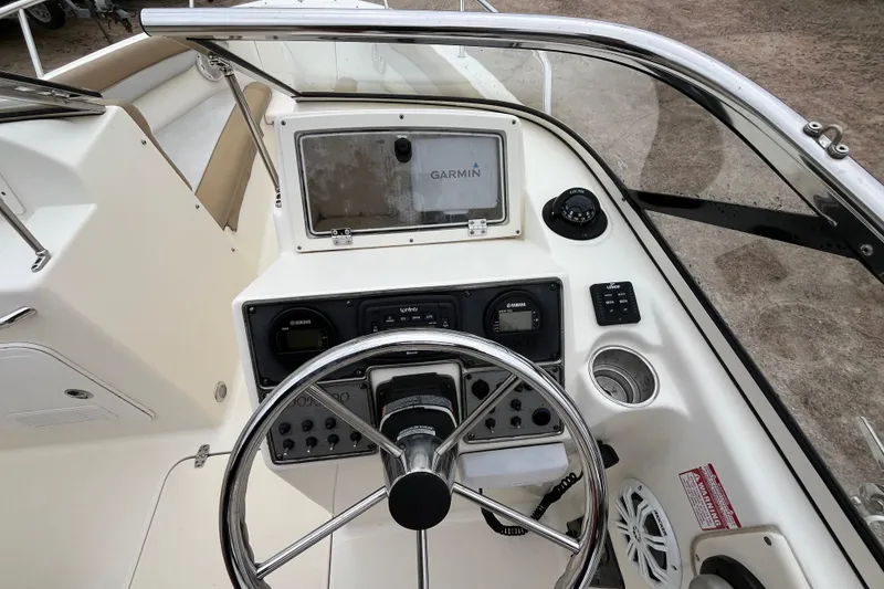 Slide: The Image of 2015 Scout 210 Dorado boat dashboard with Garmin navigation system and steering wheel. - 15