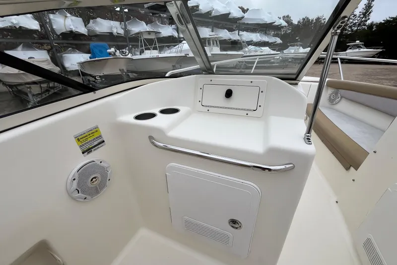 Slide: The Image of 2015 Scout 210 Dorado boat interior with storage compartment and cup holders. - 17