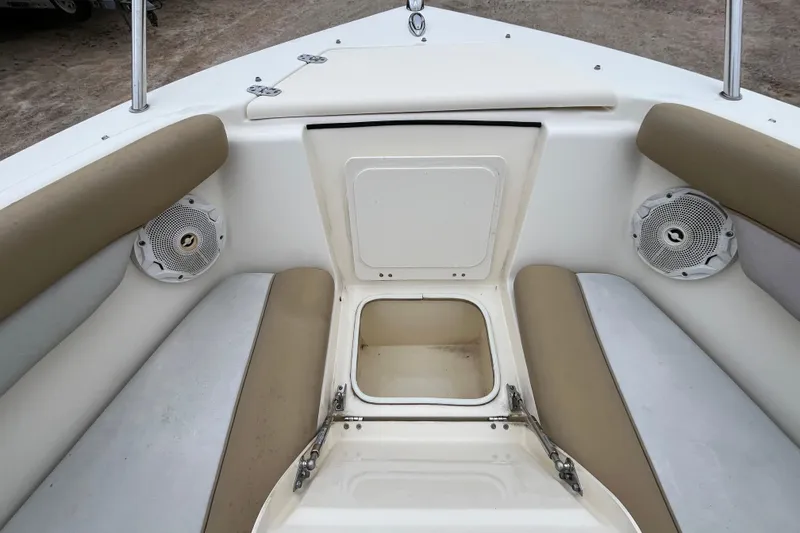 Slide: The Image of 2015 Scout 210 Dorado boat interior with storage compartment and speakers. - 22