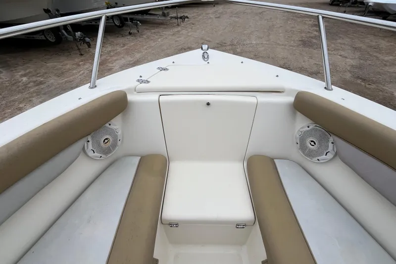 Slide: The Image of 2015 Scout 210 Dorado boat interior with beige seating and speakers. - 23