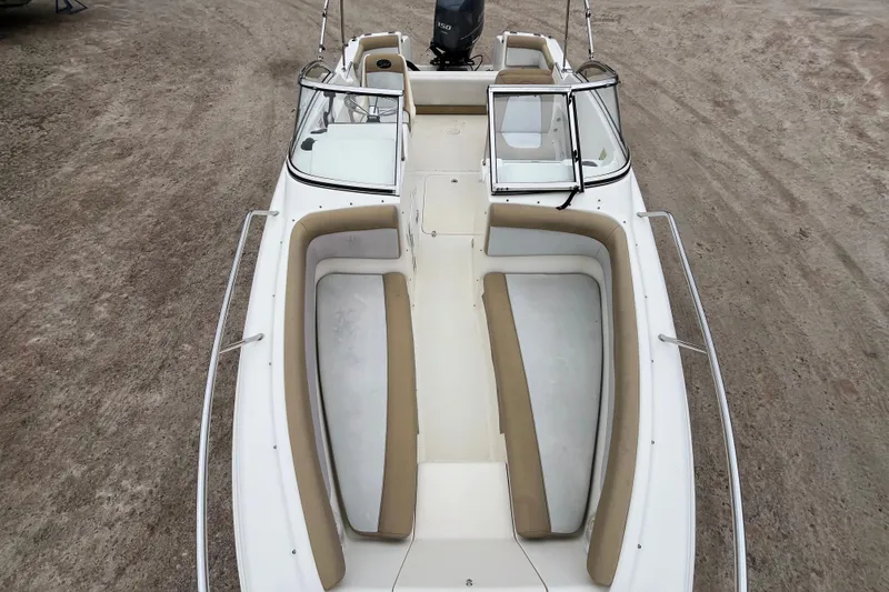 Slide: The Image of 2015 Scout 210 Dorado boat with beige seating and open deck layout. - 28