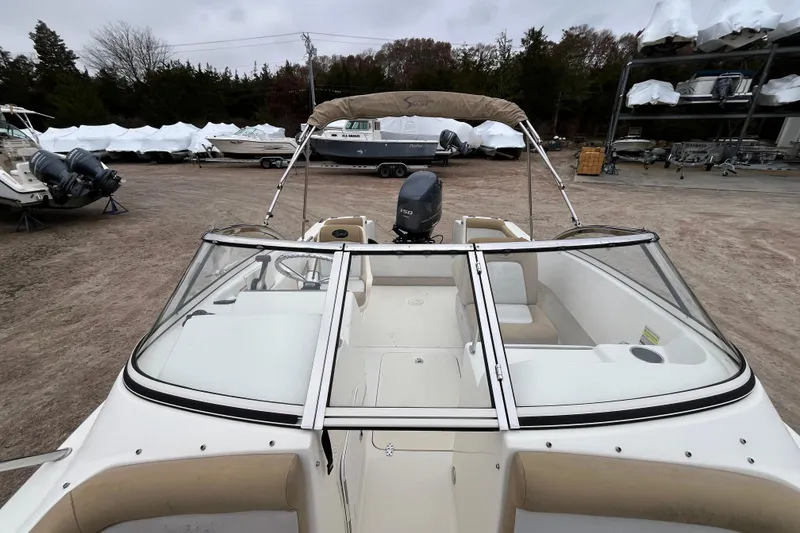 Slide: The Image of 2015 Scout 210 Dorado boat with Yamaha engine, parked in a boatyard. - 30