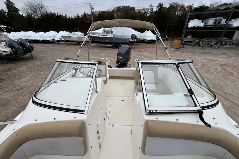 Slide: The Image of 2015 Scout 210 Dorado boat with dual windshields and Yamaha outboard motor in a storage yard. - 31
