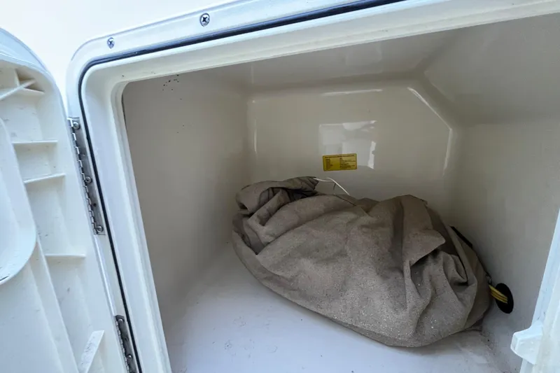 Slide: The Image of Storage compartment of 2015 Scout 210 Dorado boat with a tarp inside. - 36