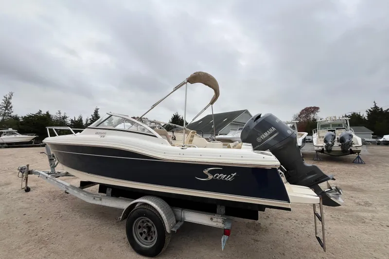 Slide: The Image of 2015 Scout 210 Dorado boat with Yamaha 150 engine on trailer, overcast day. - 5