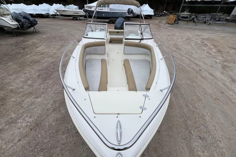 Slide: The Image of 2015 Scout 210 Dorado boat with beige seating, parked on gravel lot. - 8