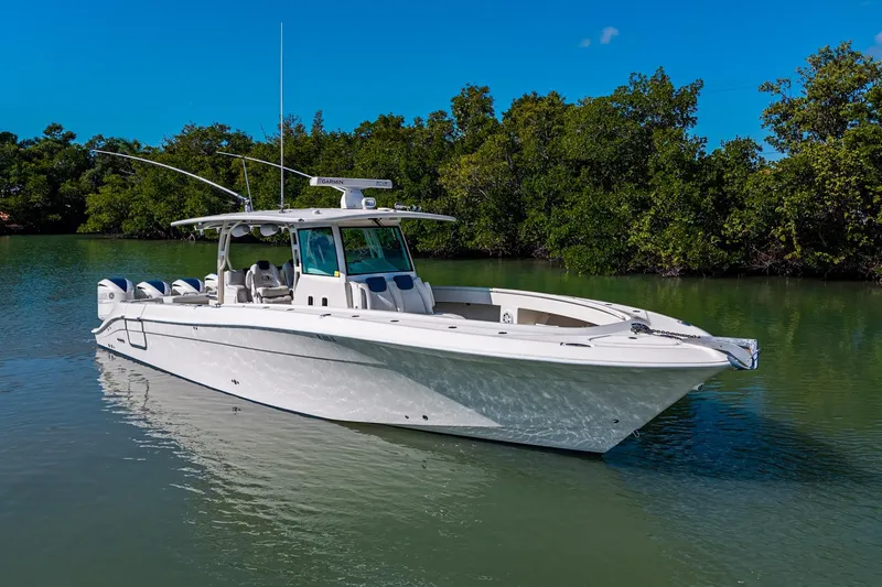 The Image of 2018 HCB 42 Siesta boat on calm water with palm trees in the background. - 0