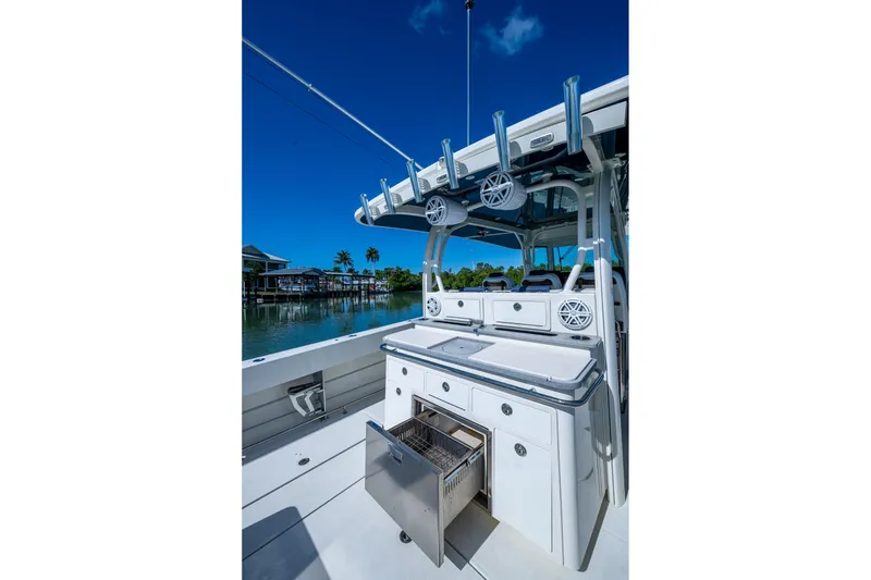 Slide: The Image of 2018 HCB 42 Siesta boat on calm water, featuring spacious deck and modern amenities. - 21