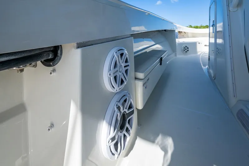 Slide: The Image of 2018 HCB 42 Siesta boat with open storage, sleek design, and scenic waterfront view. - 22