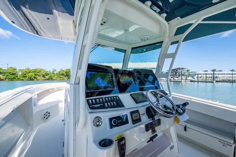 Slide: The Image of 2018 HCB 42 Siesta boat interior with luxurious seating and scenic waterfront view. - 27