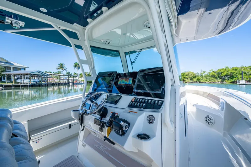 Slide: The Image of 2018 HCB 42 Siesta boat helm with advanced navigation systems and waterfront view. - 28