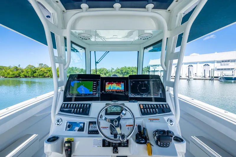 Slide: The Image of 2018 HCB 42 Siesta boat helm with advanced navigation system and waterfront view. - 29