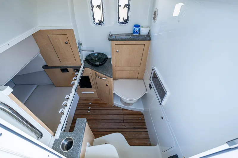 Slide: The Image of 2018 HCB 42 Siesta boat with rod holders and speakers against a clear blue sky. - 32