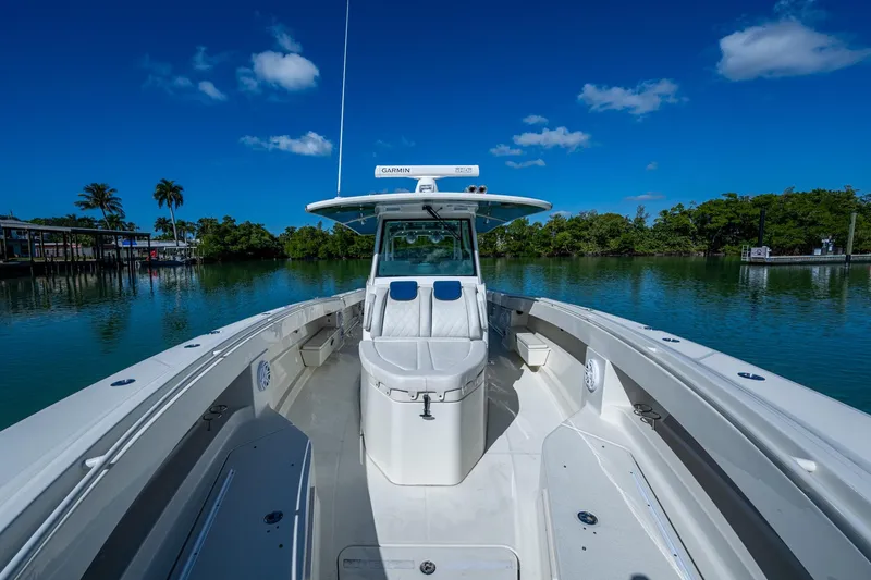 Slide: The Image of 2018 HCB 42 Siesta boat interior with open storage compartments on calm water. - 38